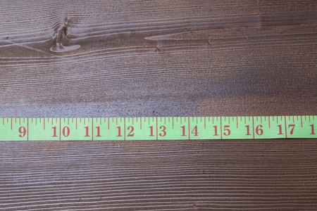 Measuring tape on wooden table. Diet conceptの写真素材