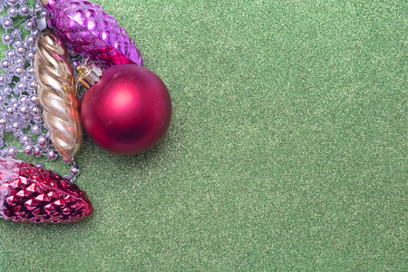 Three christmas toy bump and christmas red ball on green background. Empty space for textの写真素材