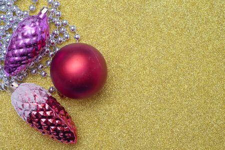 Two christmas toy bump and christmas red ball on yellow background. Empty space for textの写真素材