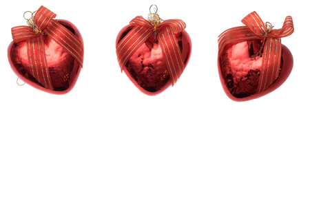 Three christmas heart shaped red ball isolated on white background. Empty space for textの写真素材