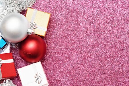 Small boxes for gift and two christmas ball on red background, Empty space for textの写真素材