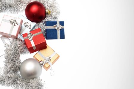 Small boxes for christmas gift, christmas balls and christmas tinsel on white background, Empty space for textの写真素材