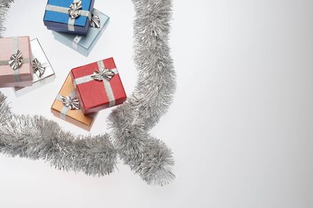 Small boxes for christmas gift, christmas balls and christmas tinsel on white background, Empty space for textの写真素材