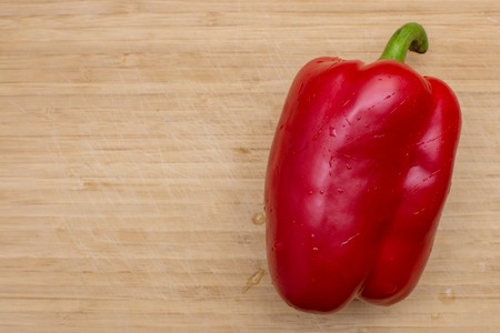 Red ripe sweet bell peppers on wooden background, Top view, rustic style.の写真素材