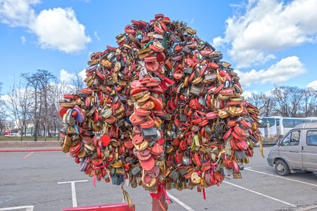 MOSCOW, RUSSIA - March 23, 2017: Tree with the locked wedding locks on the Bridge of Love.のeditorial素材