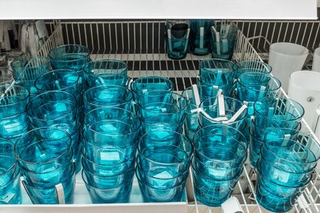 This images contains set of blue glasses in the storeの写真素材