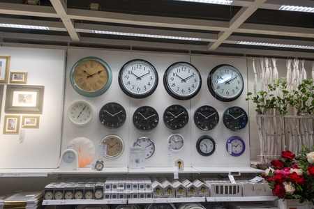 RUSSIA, MOSCOW, JUNE 13, 2017: Many different wall clock on the wall in Ikea storeのeditorial素材
