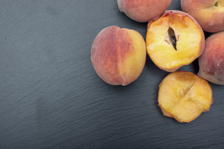 Ripe Peach ion black background of slate or stone.の写真素材
