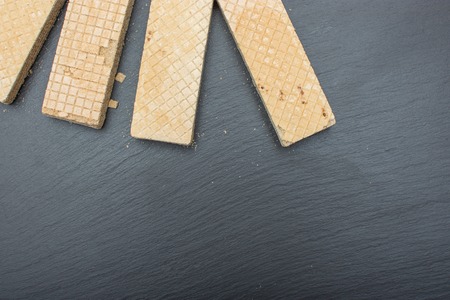 Classic Russian waffles on black background of slate or stone. Free Space for textの写真素材