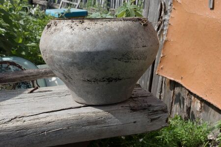 Old Cast-iron cauldron on a wooden board.の写真素材