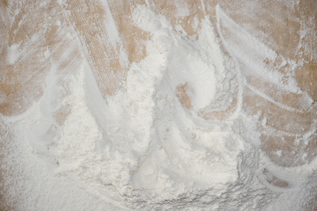 White flour on wooden table. Top view.の写真素材