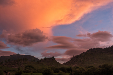 Beautiful clouds in the background silhouette of the mountains at sunsetの写真素材