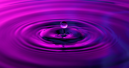 A drop of water falls and leaves ripples.の写真素材