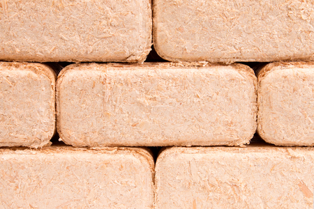 Briquettes made of sawdust lie on a white background.の写真素材