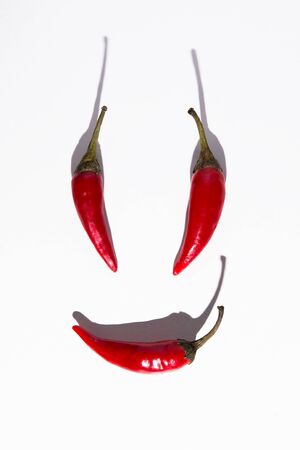 Red hot peppers is depicted as a person. White backgroundの写真素材