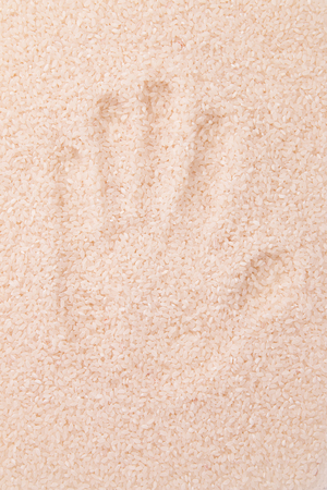 Handprint on white rice.の写真素材