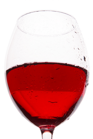 A glass of wine on a white background. Red wine on a white backgroundの写真素材