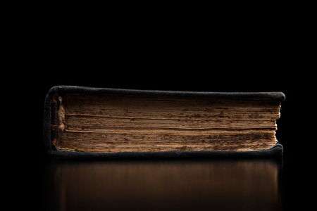 Old closed book on a black background. Ancient book on a black background.の写真素材