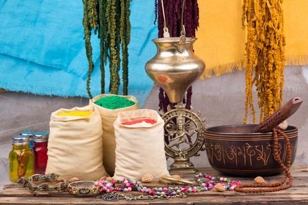 Singing bowl and other ritual objects. Multicolored ornaments close-up on a wooden background.の写真素材