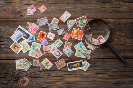 Collection of postage stamps. Postage stamps on the table. Philatelism