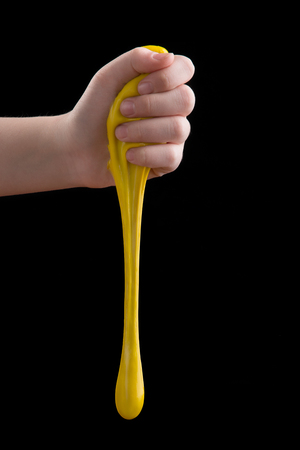 Games mucus in child's hands on a black backgroundの写真素材