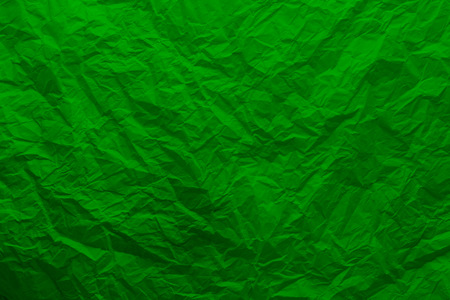 A sheet of crumpled green paperの写真素材