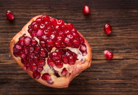 Fresh garnet on a wooden backgroundの写真素材