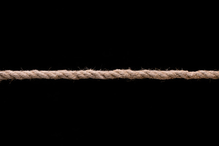 Stretched jute rope on a black background