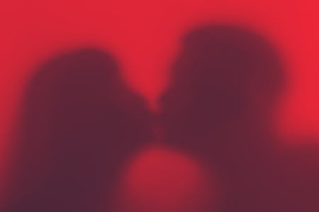Silhouette of a loving couple during a kiss.
