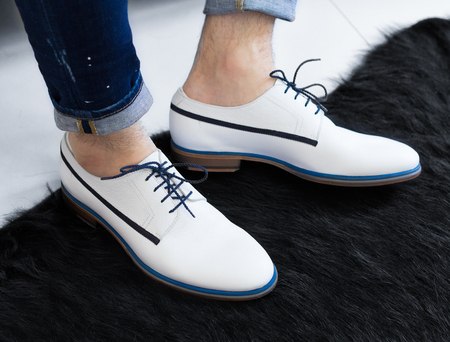 A man in white fashionable shoes. A man in white fashionable shoes and jeans.の写真素材