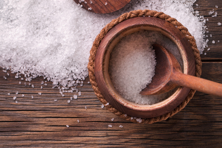 Sea salt in a wooden keg. Crystals of sea salt on a wooden table.の写真素材
