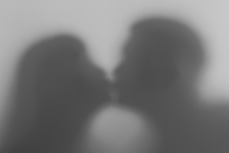 Silhouette of a loving couple during a kiss. Silhouette of lovers.の写真素材