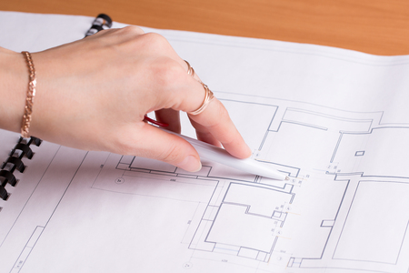 Realtor shows a real estate plan. Apartment plan close up.の写真素材