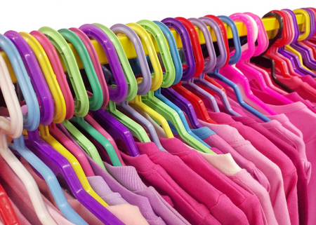 Colored clothes on hangers close-up.の写真素材