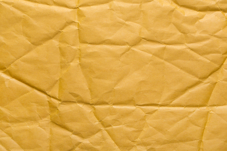 Crumpled yellow paper closeup.の写真素材
