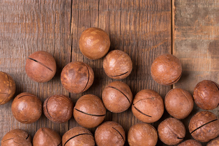 Macadamia nuts on a wooden background.の写真素材