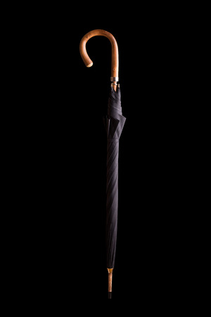 Elegant umbrella cane folded on a black background.の写真素材