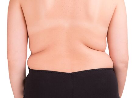 Overweight problem. Girl body with fat side isolate on a white background.の写真素材