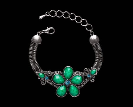 A beautiful silver bracelet in the shape of a flower made of turquoise stones.
