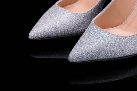 Shiny silver shoes with a pointed toe close-up.の写真素材
