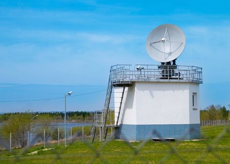 Building with a satellite dish attached to it.
