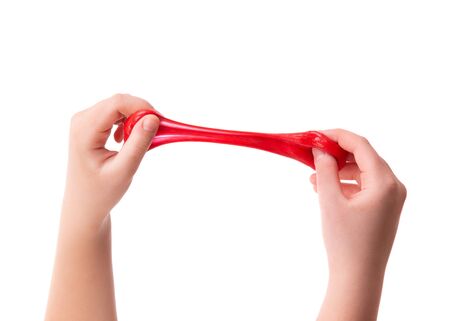 Child pulls a red slime toy.の写真素材