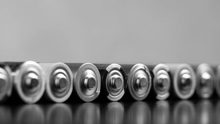 A set of finger batteries lying on the table. The concept of used batteries.の写真素材