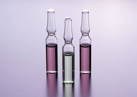 Glass ampoules on the table. Scattered ampoules with medicine.