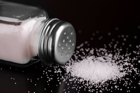 Salt and salt shaker close-up.の写真素材