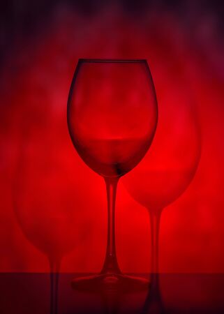 Wine glasses on a red background. Abstraction.の写真素材