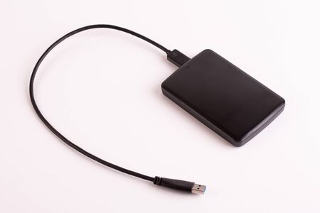 Portable hard drive with usb wire on a white background.