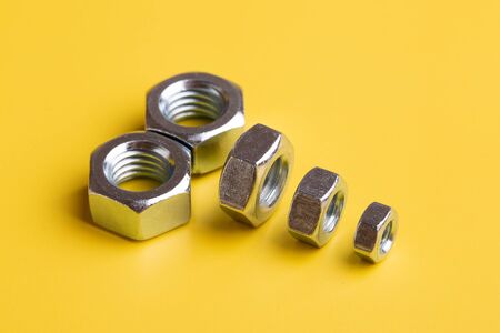 Female screw on a yellow background. The concept of an iron penis.の写真素材