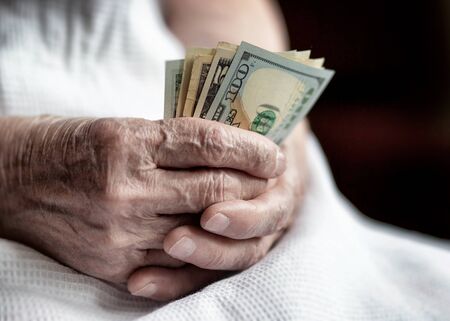 Elderly woman with money in hand.の写真素材