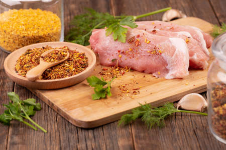 Raw pork tenderloin on a cutting board.の写真素材
